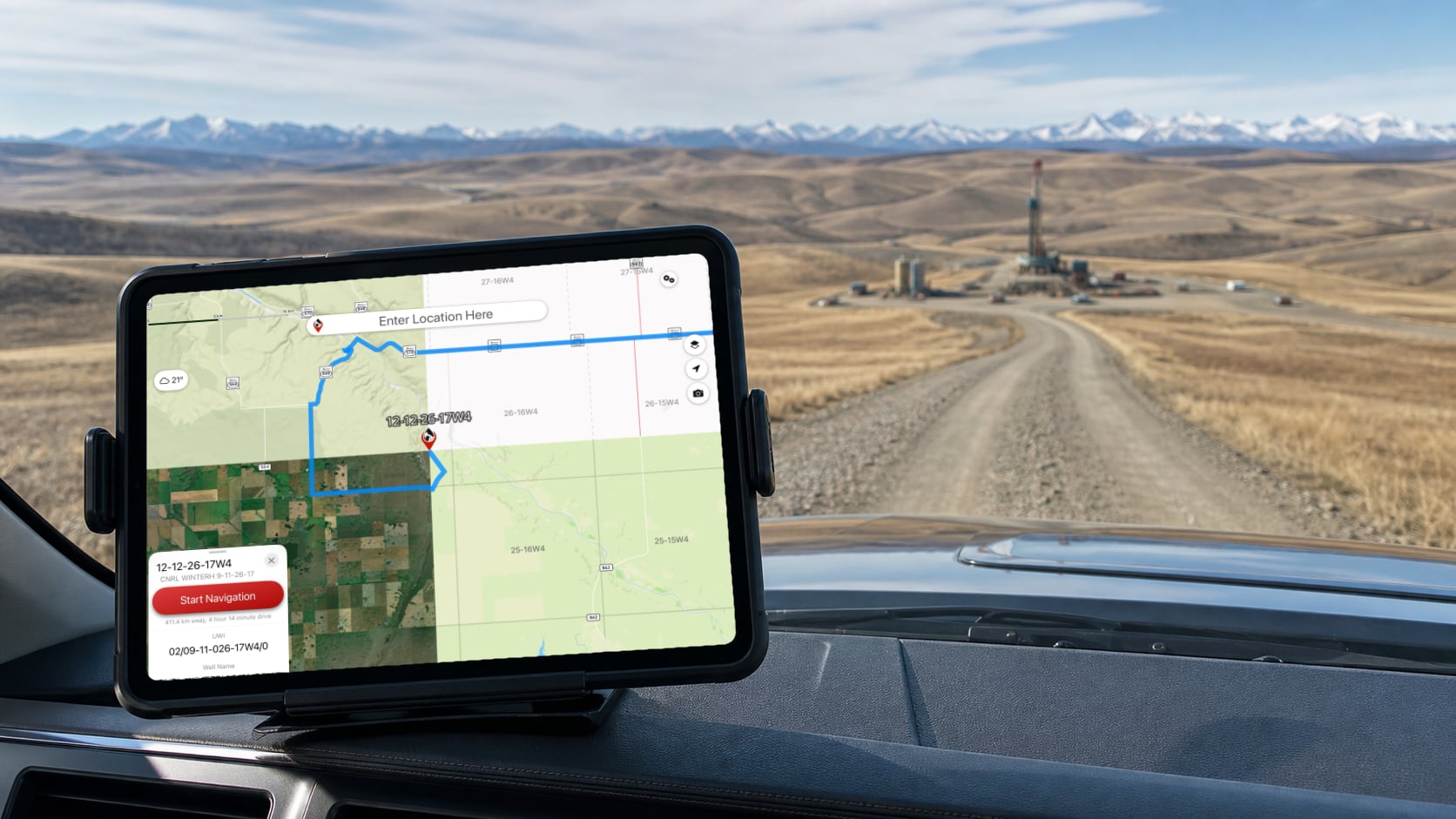 A tablet in a truck showing multiple oilfield map layer views while approaching a rural lease road.