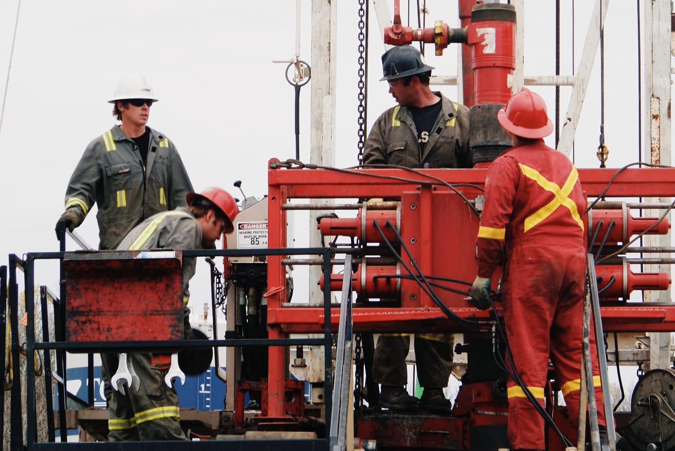 Ash Point CEO, Craig Hewlett, assisting his crew rig up wireline BOPs in Northern BC in 2008.